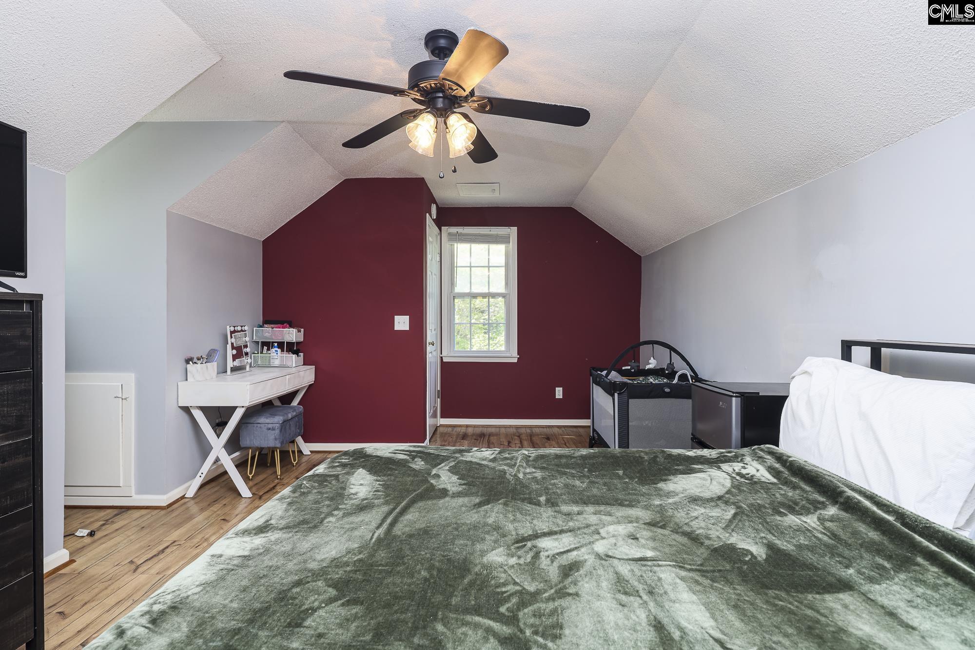 152 Thames Valley Court Irmo, SC 29063 - Photo 27 of 32 a bedroom with a bed and a chandelier