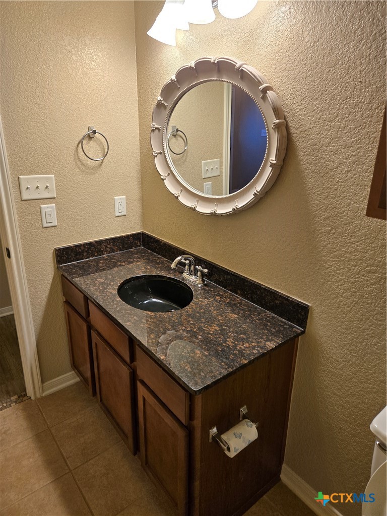 6308 Roxbury Avenue Temple, TX 76502 - Photo 21 of 26 a bathroom with a sink and mirror