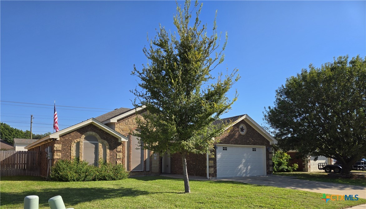 6308 Roxbury Avenue Temple, TX 76502 - Photo 3 of 26 a front view of a house with a yard and garage