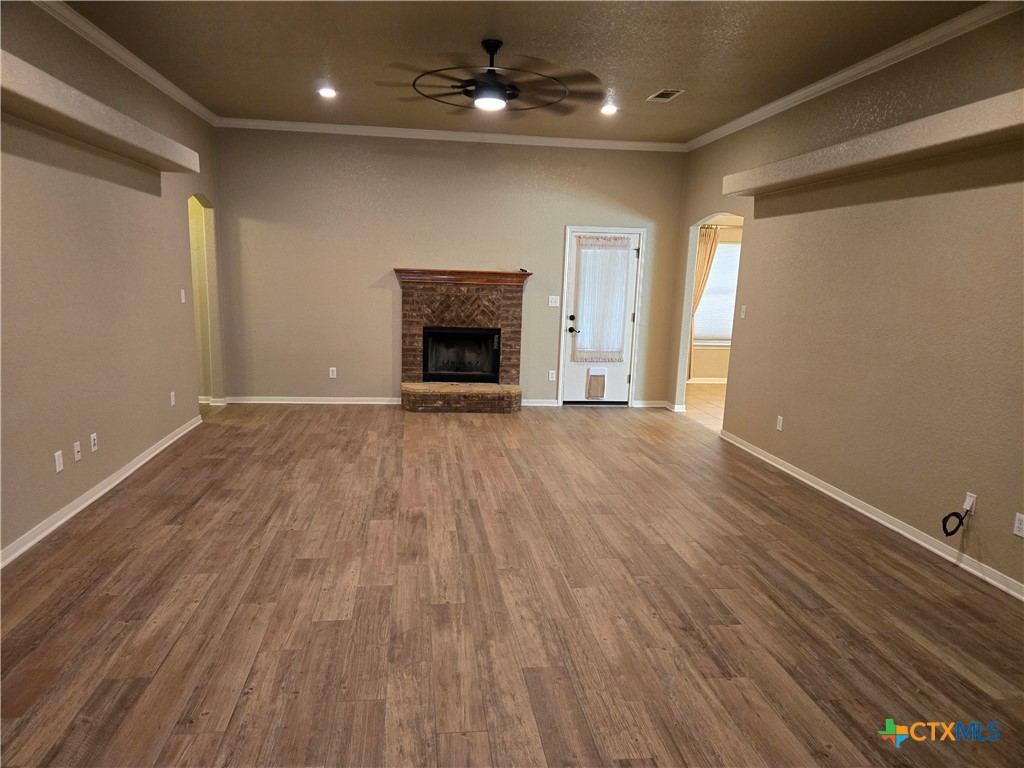 6308 Roxbury Avenue Temple, TX 76502 - Photo 6 of 26 wooden floor in an empty room with a fireplace
