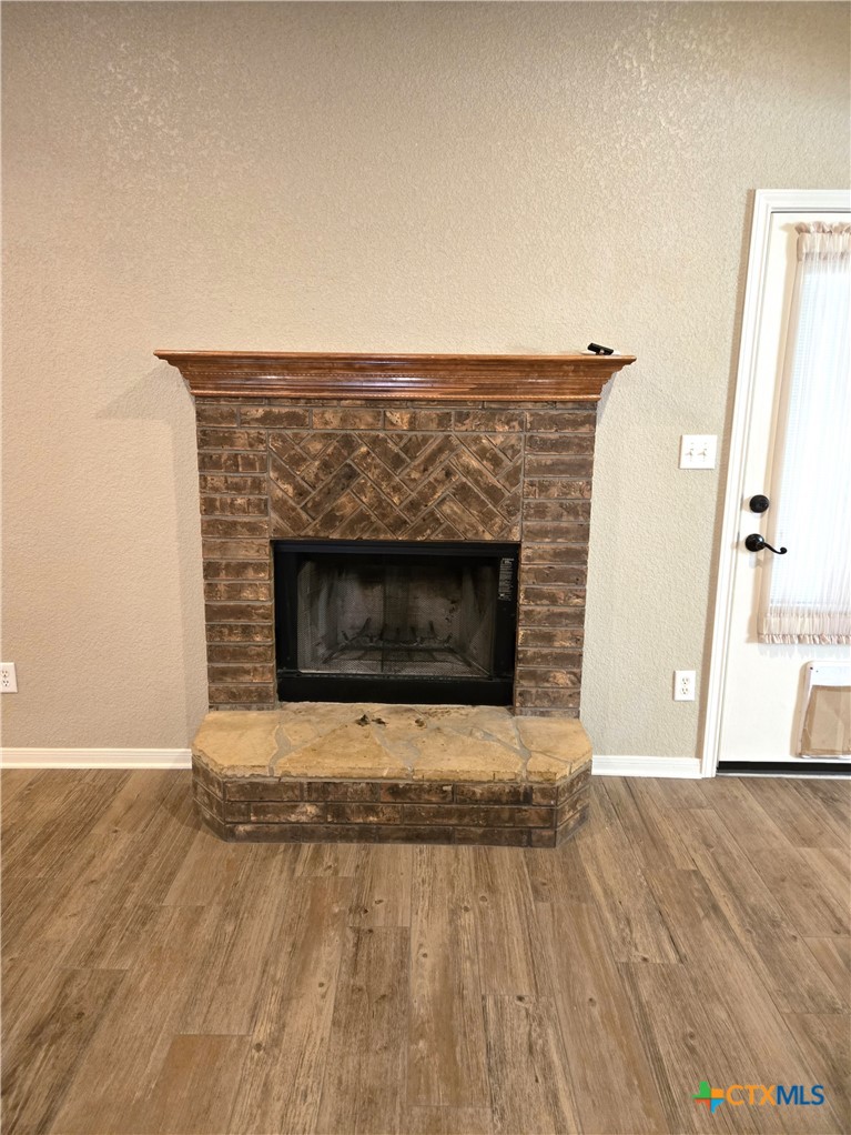 6308 Roxbury Avenue Temple, TX 76502 - Photo 8 of 26 a living room with a fireplace and wooden floor