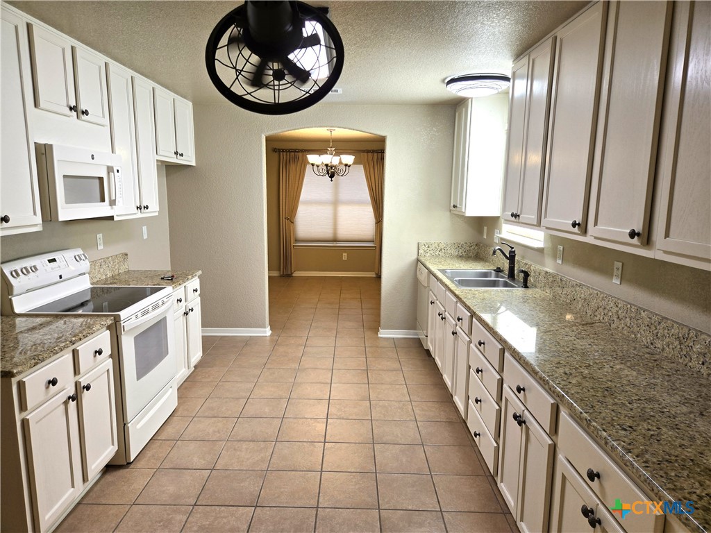 6308 Roxbury Avenue Temple, TX 76502 - Photo 9 of 26 a large kitchen with granite countertop lots of counter top space and stainless steel appliances