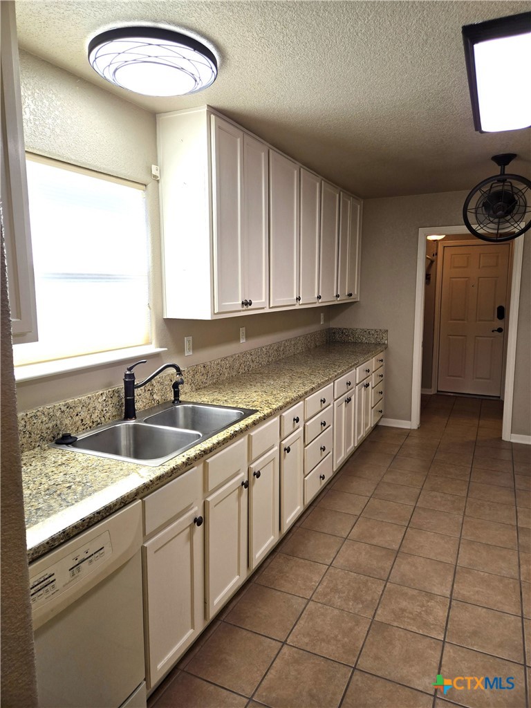 6308 Roxbury Avenue Temple, TX 76502 - Photo 10 of 26 a kitchen with a sink and cabinets