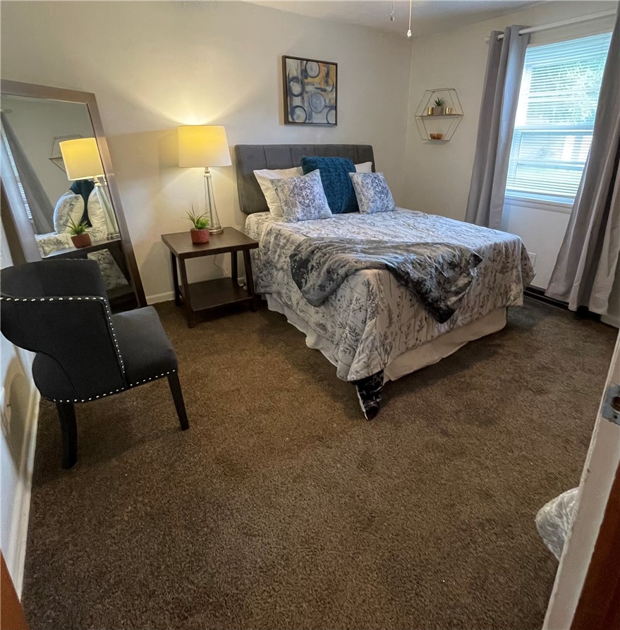 360 Ridge Street Piqua, OH 45356 - Photo 18 of 46 This cozy bedroom features plush carpet and ample natural light, creating a tranquil retreat.