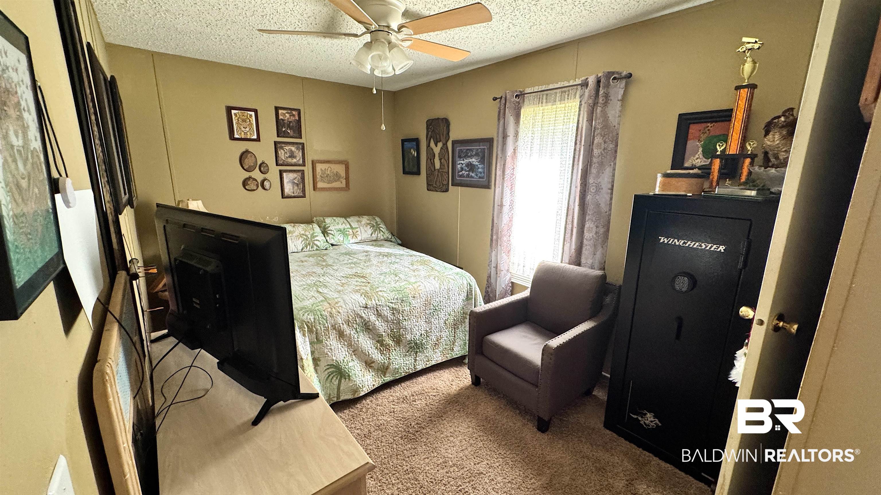 17897 Little Rock Road Foley, AL 36535 - Photo 11 of 24 Carpeted bedroom featuring a textured ceiling and a ceiling fan