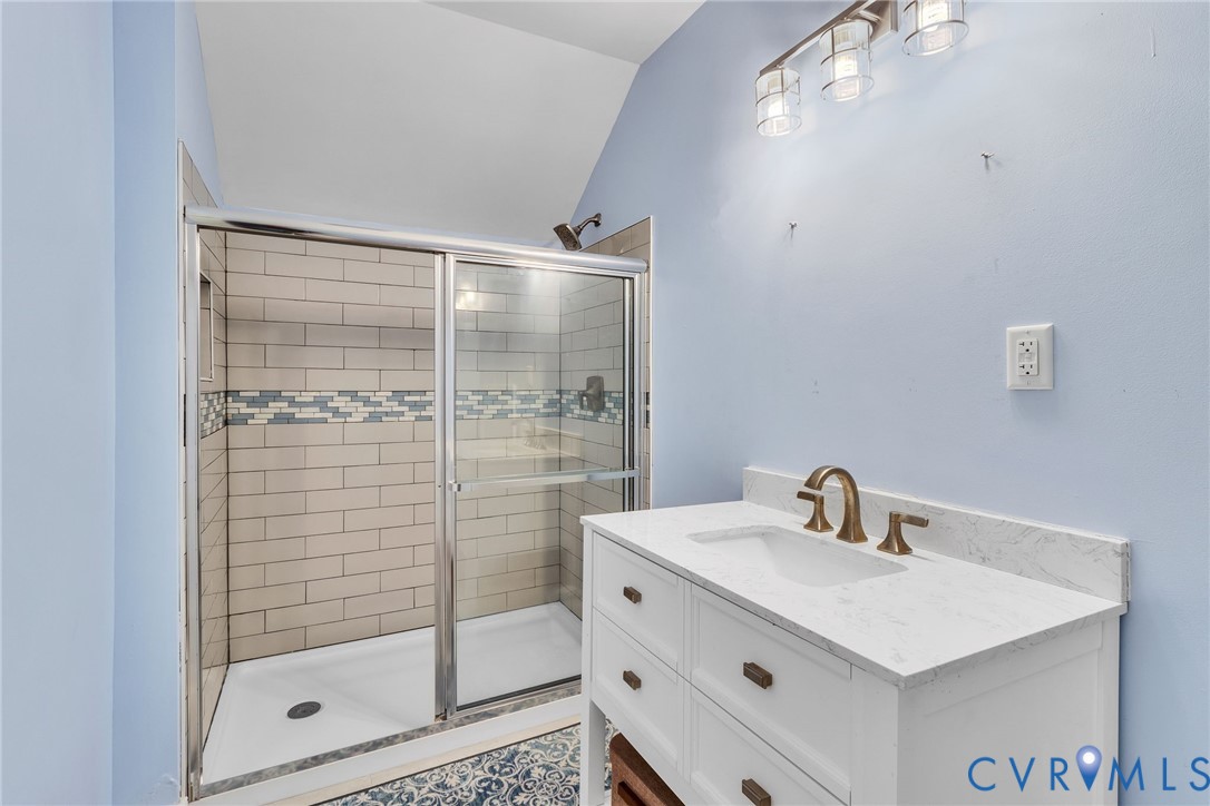 5337 Irvington Road White Stone, VA 22578 - Photo 47 of 53 Full bathroom with vanity, a stall shower, and vau