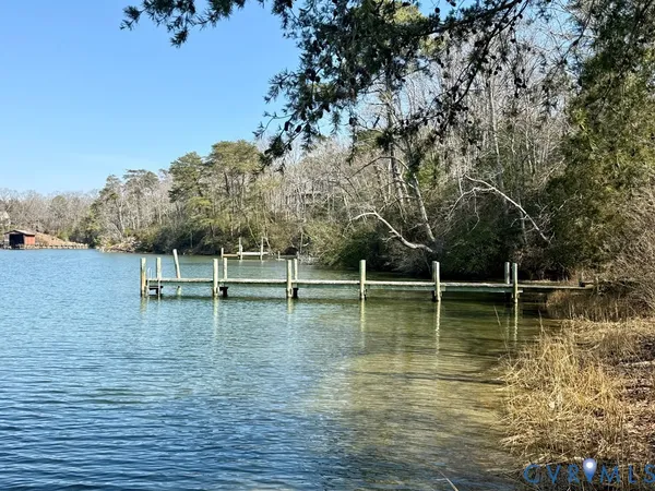 a view of a lake with boats and trees in the background