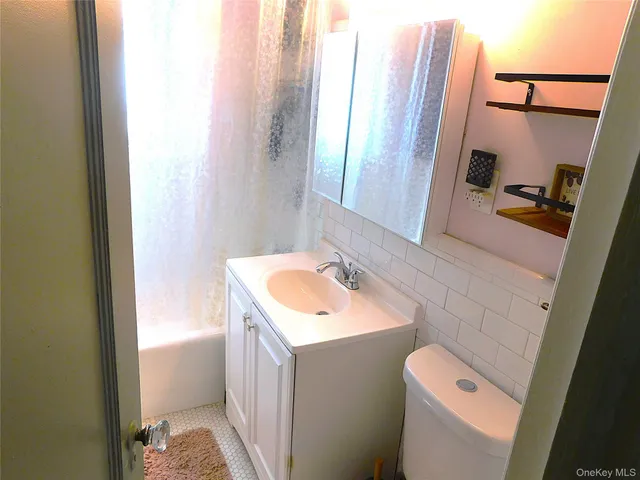 a bathroom with a sink a toilet and a mirror