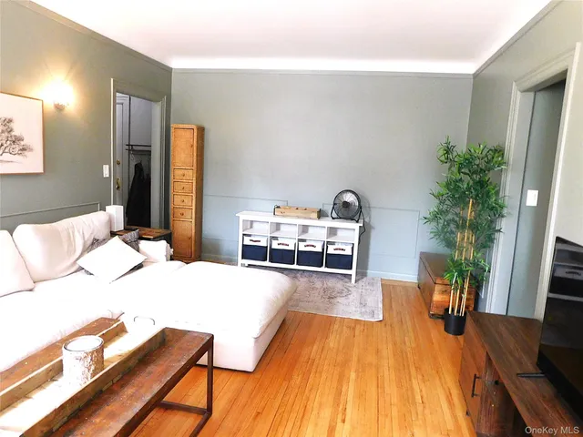 a bedroom with furniture and wooden floor