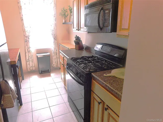 a kitchen with a stove a sink and a microwave