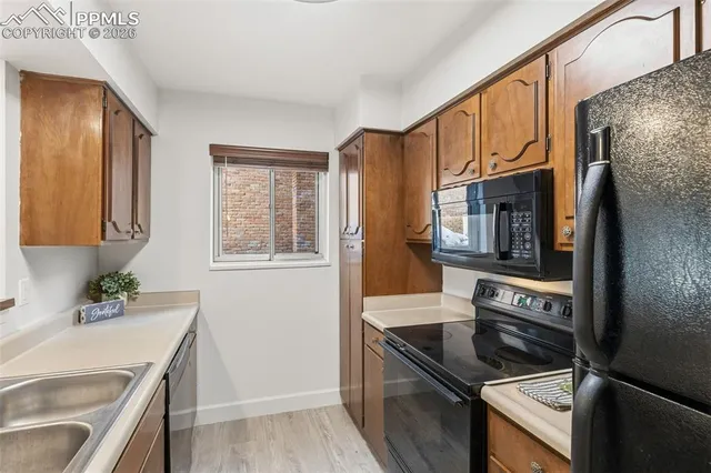 a kitchen with granite countertop a refrigerator stove and microwave