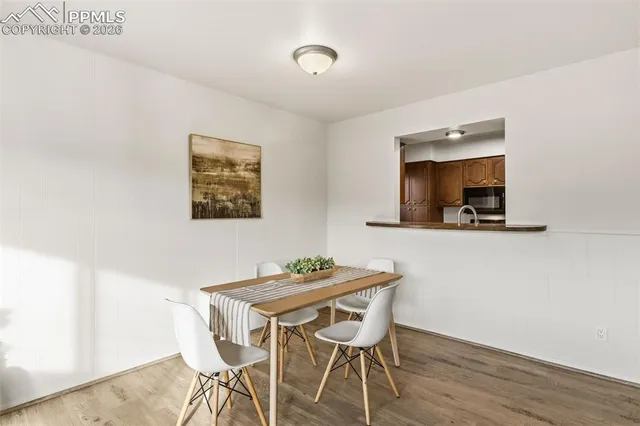 a dining room with furniture and wooden floor