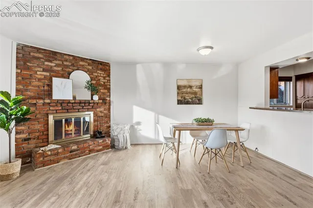 a living room with furniture a dining table and a wooden floor
