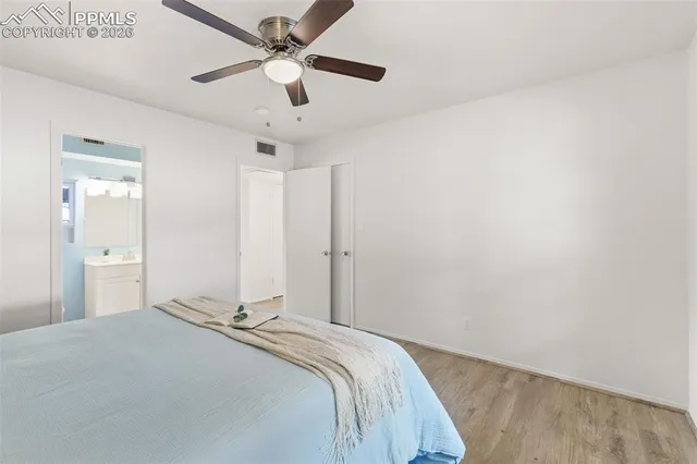 a bedroom with a bed and a potted plant