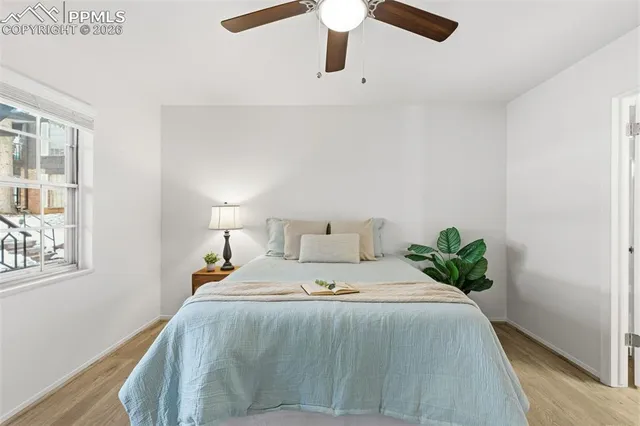 a bedroom with a bed and a large window