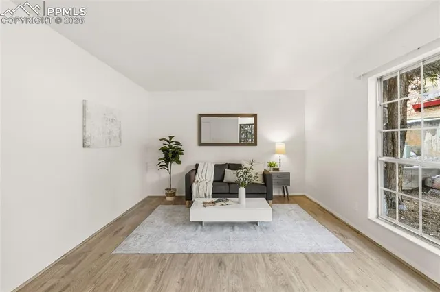 a living room with furniture and wooden floor