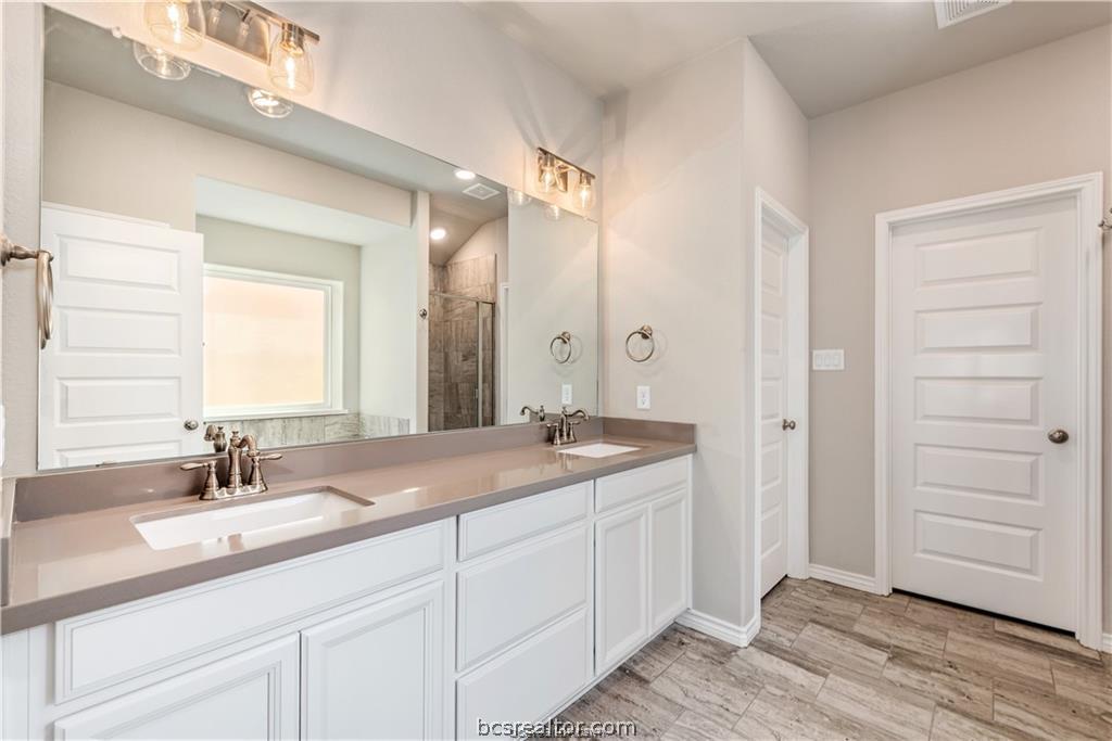 3185 Normandy Way Bryan, TX 77808 - Photo 9 of 16 a bathroom with a sink and a mirror