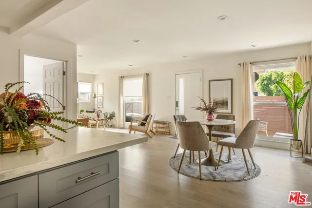 a dining room with furniture and wooden floor