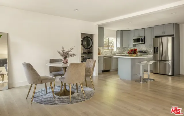 a kitchen with appliances a sink cabinets and wooden floor