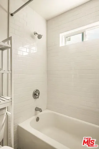 a bathroom with double vanity sinks and a mirror