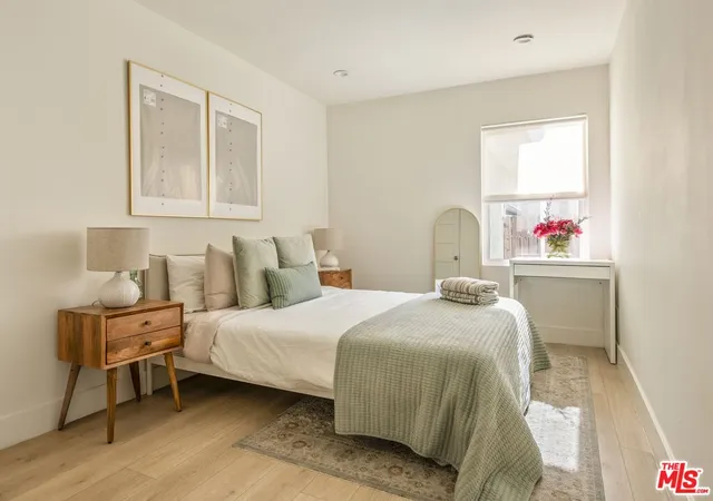 a bedroom with furniture and a window