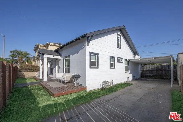 a front view of a house with porch and furniture