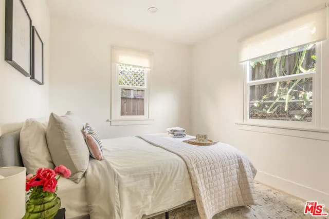 a bedroom with a bed and lamp