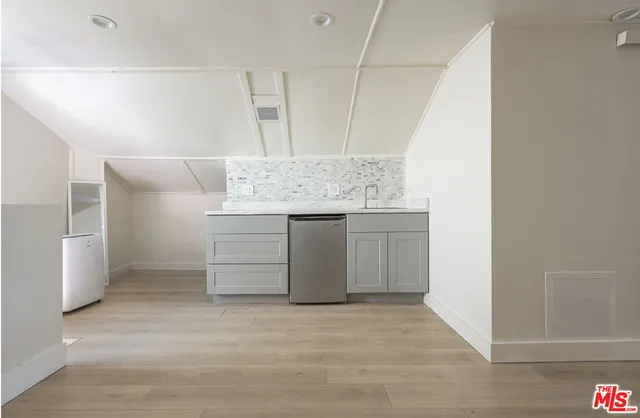 a view of a kitchen from a hallway