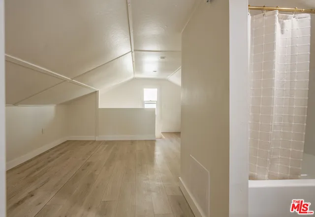 a bathroom with a tub shower and sink