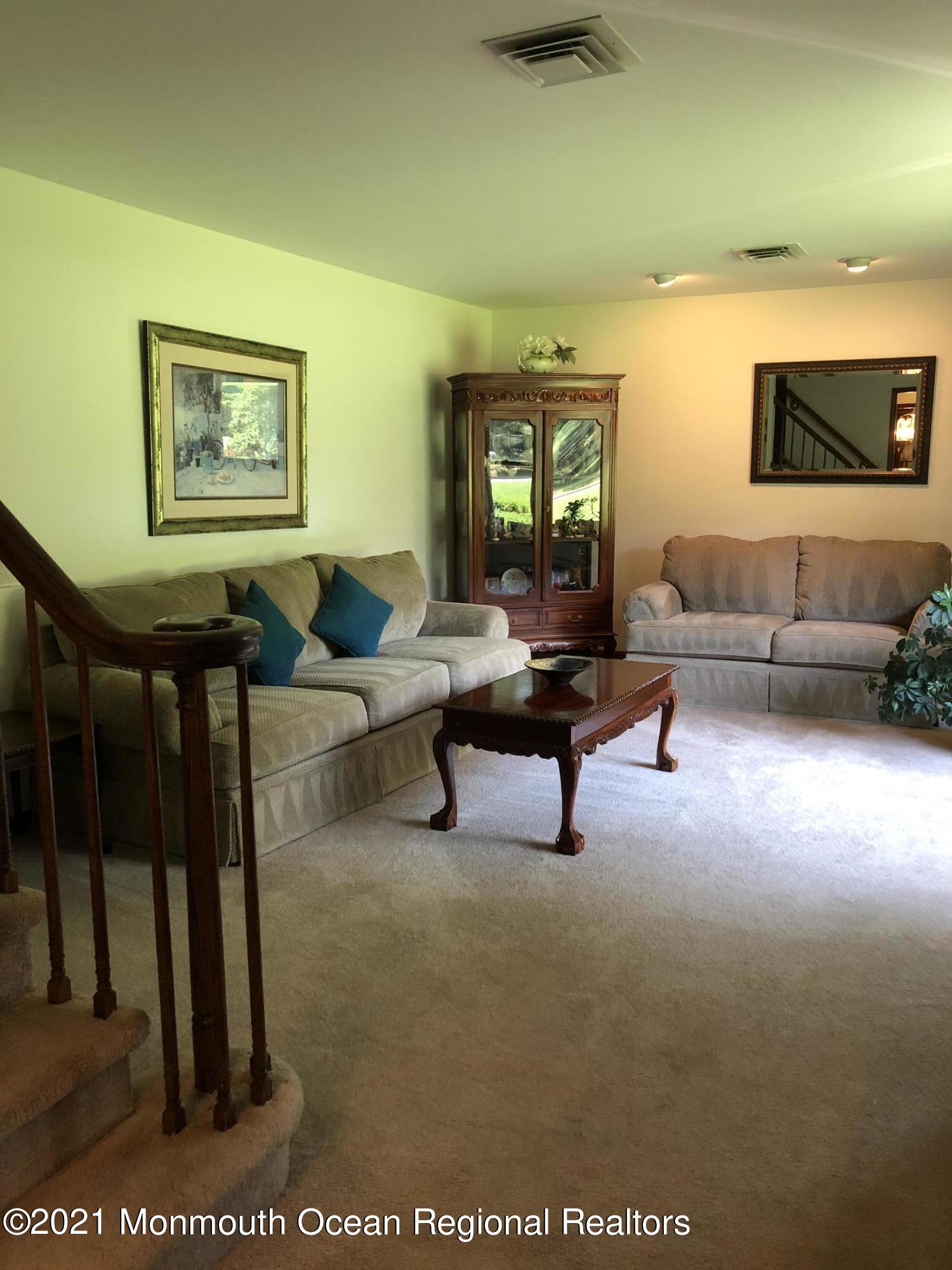 2 Hunt Road Freehold, NJ 07728 - Photo 12 of 35 a living room with furniture and a flat screen tv