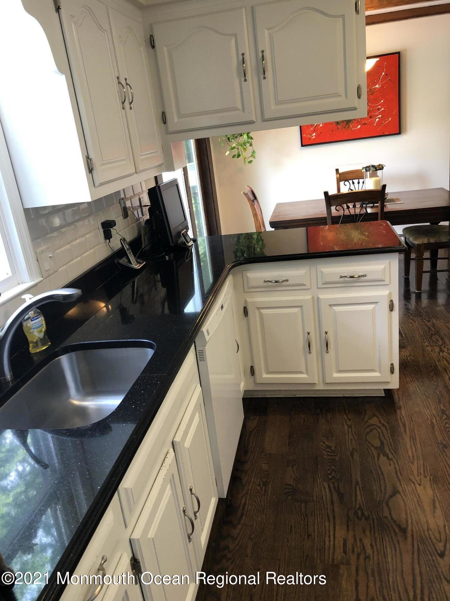 2 Hunt Road Freehold, NJ 07728 - Photo 18 of 35 a kitchen with a sink a stove and cabinets
