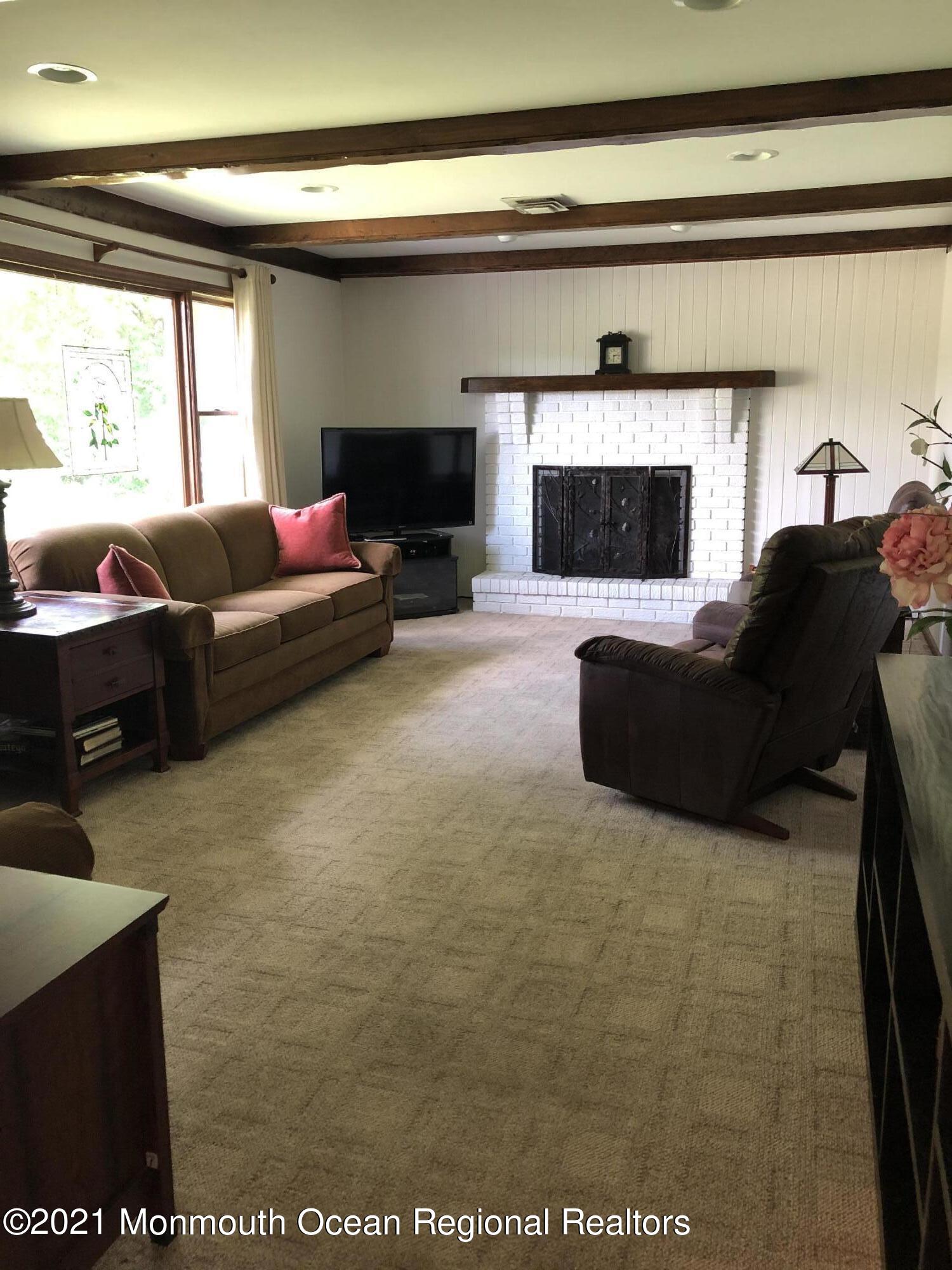 2 Hunt Road Freehold, NJ 07728 - Photo 20 of 35 a living room with furniture and a flat screen tv
