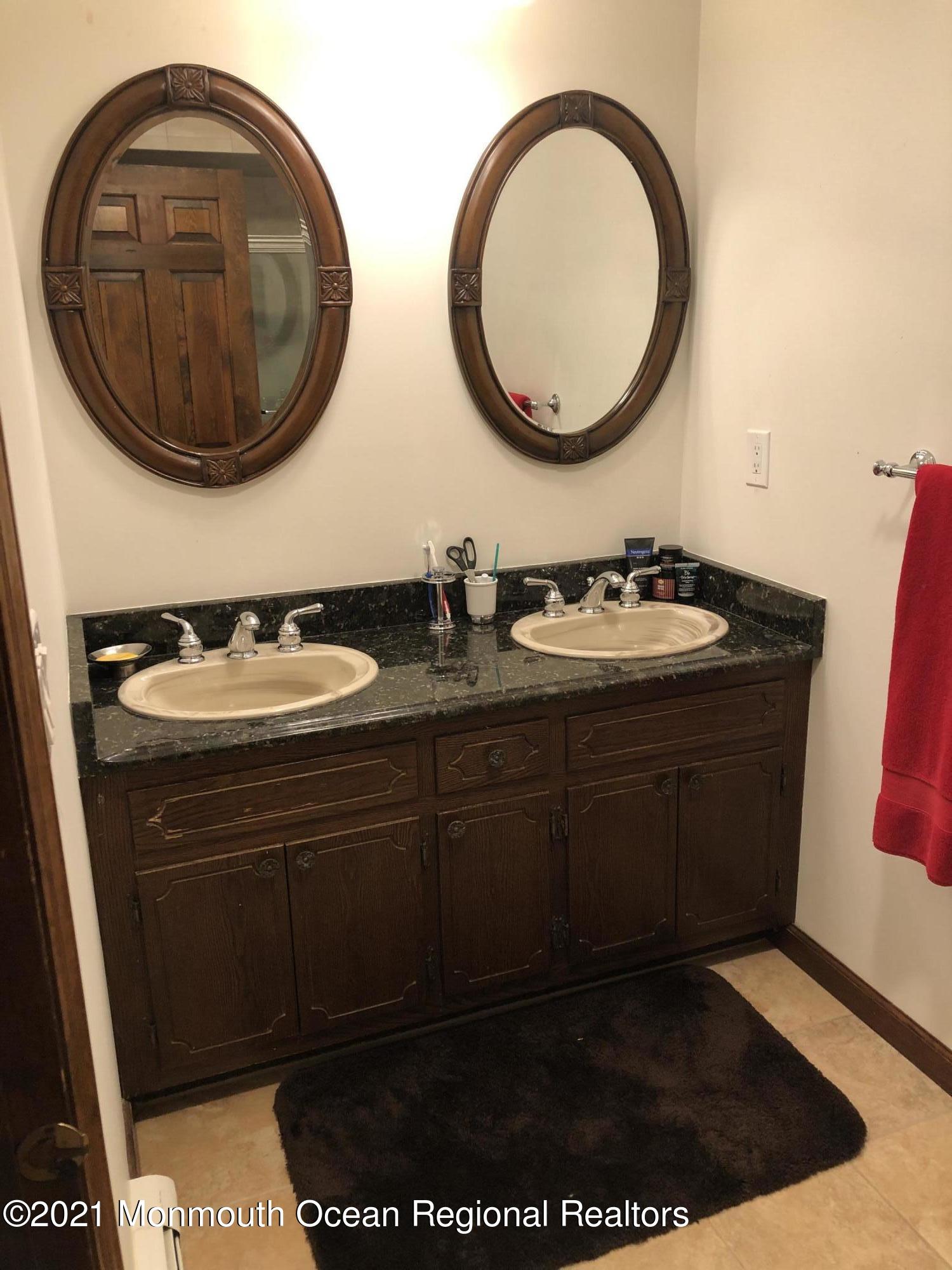 2 Hunt Road Freehold, NJ 07728 - Photo 26 of 35 a bathroom with a sink and a mirror