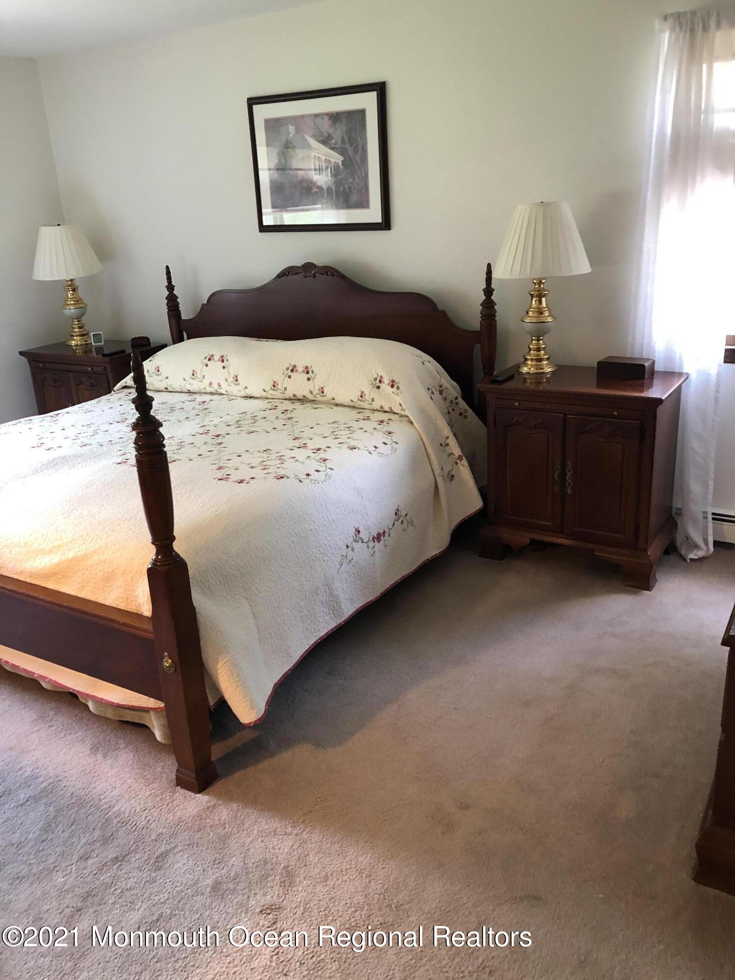 2 Hunt Road Freehold, NJ 07728 - Photo 27 of 35 a bed sitting in a bedroom next to a lamp