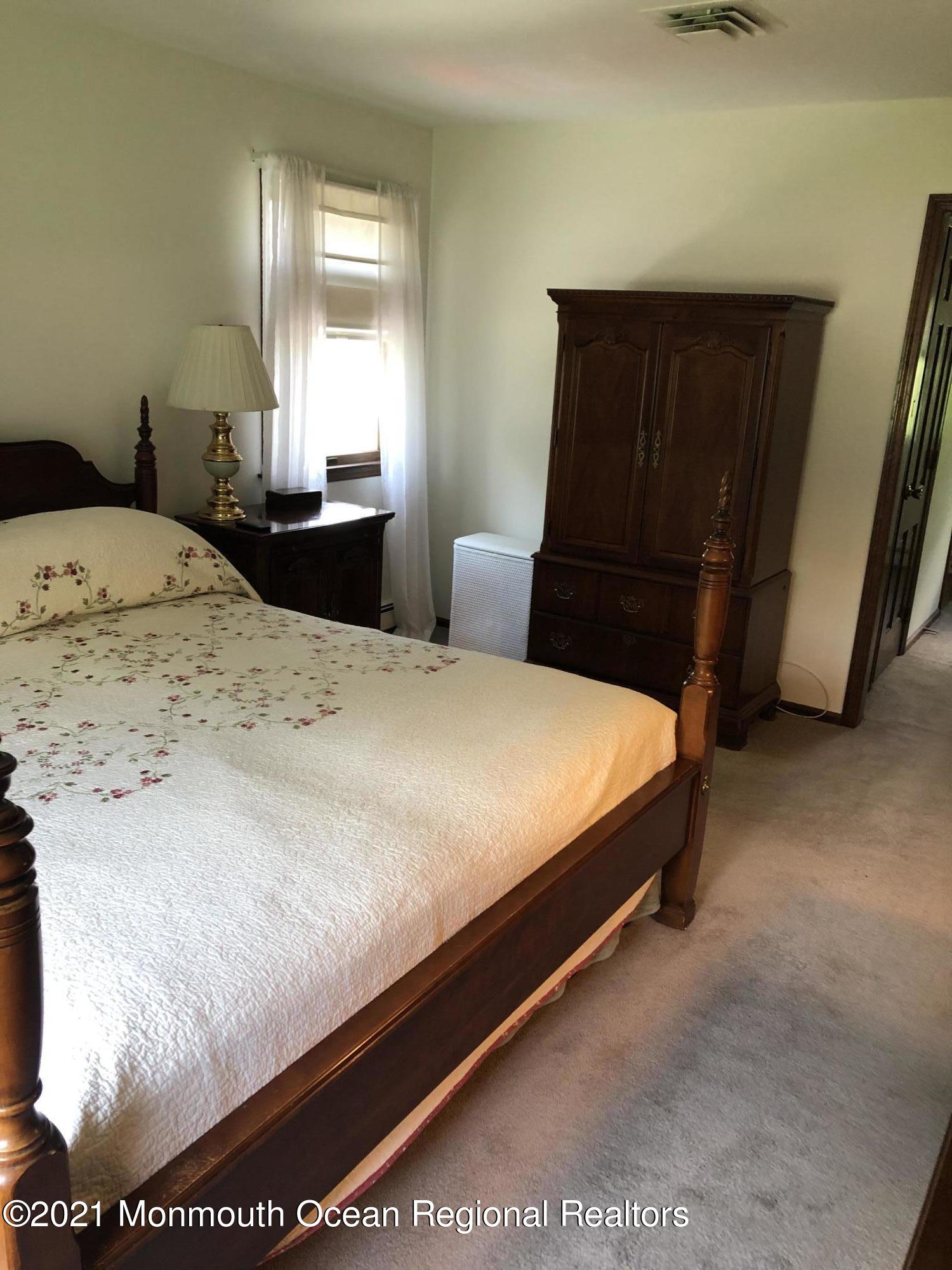 2 Hunt Road Freehold, NJ 07728 - Photo 28 of 35 a bedroom with a bed and wooden floor