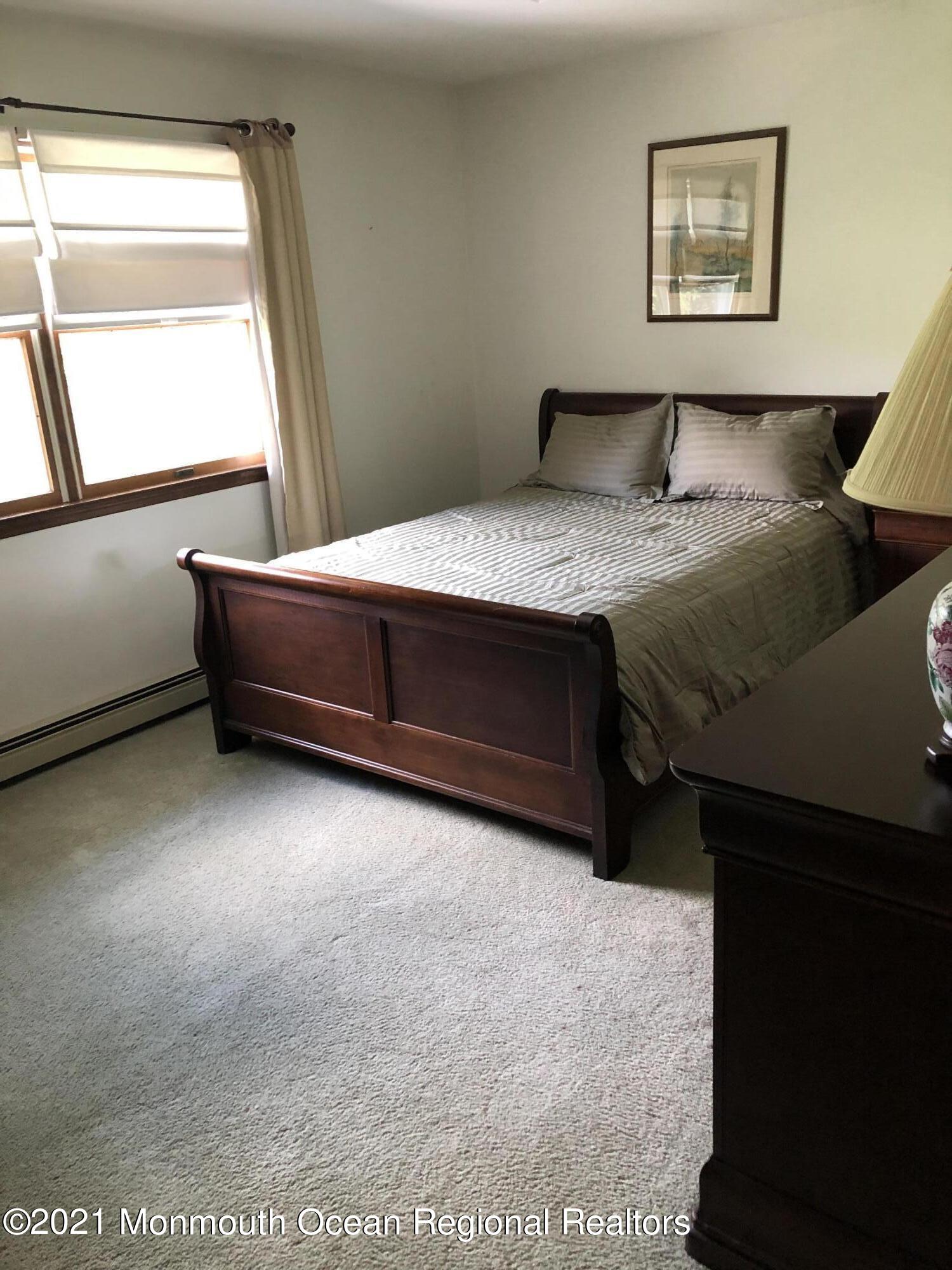 2 Hunt Road Freehold, NJ 07728 - Photo 32 of 35 a bedroom with a bed and a dresser next to a window