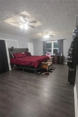 a spacious bedroom with a bed and a table in it