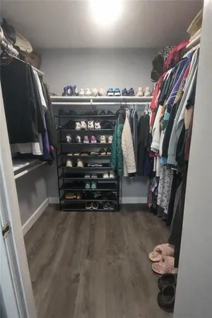 a view of walk in closet with clothes