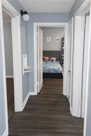 a bedroom with wooden floor and closet
