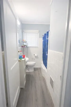 a very nice looking room with wooden floor and a window