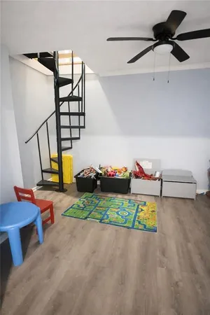 a view of a room with toys and wooden floor