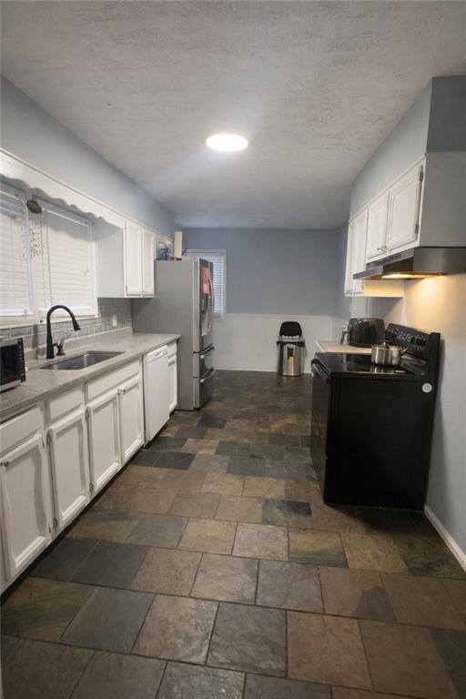 265 Winding Stream Trail Hampton, GA 30228 - Photo 6 of 29 a kitchen with a sink a stove and cabinets
