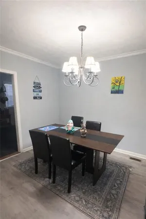 a view of a dining room with a table and chairs