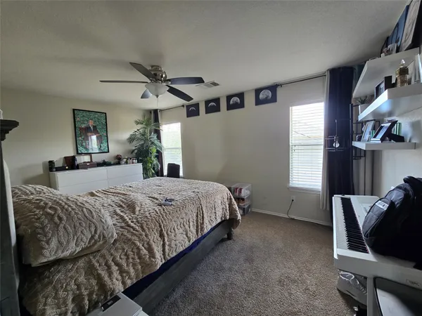 a bedroom with a bed chair and window