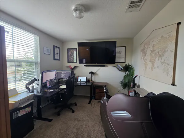 a living room with furniture window and a flat screen tv
