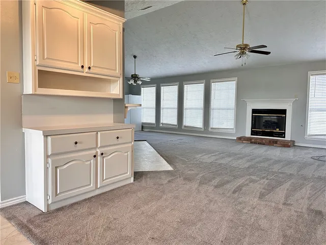 a kitchen with stainless steel appliances white cabinets and a window