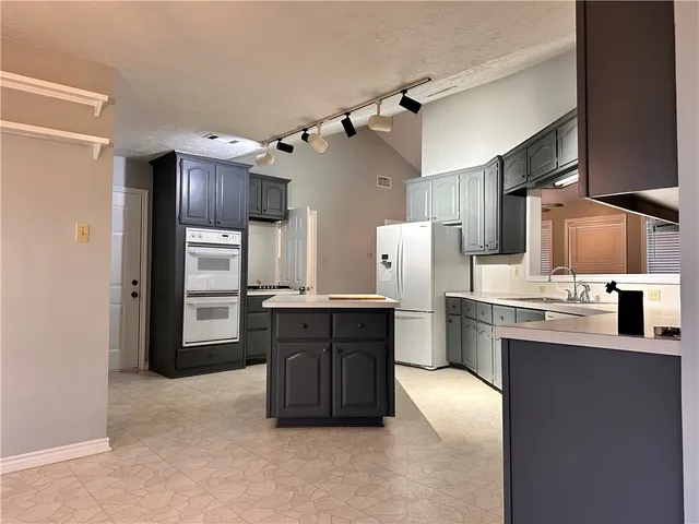 a kitchen with stainless steel appliances a refrigerator and a sink