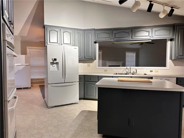 a kitchen with stainless steel appliances a sink and a refrigerator