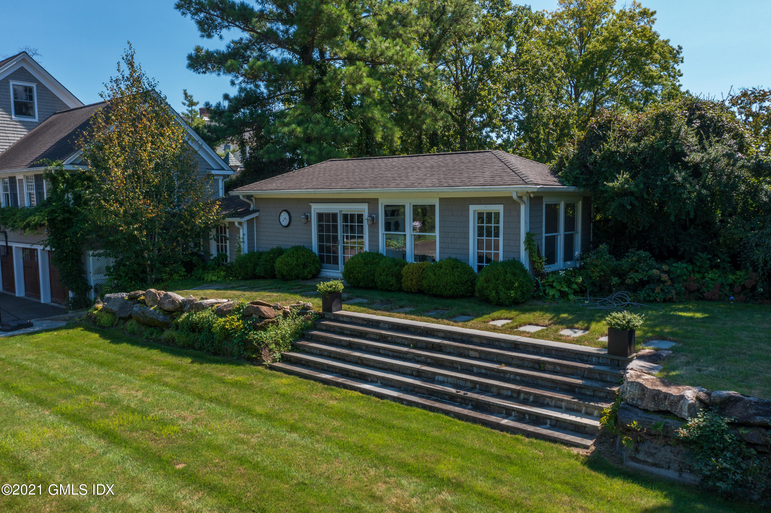20 Ballwood Road Old Greenwich, CT 06870 - Photo 26 of 32 a front view of a house with a yard table and chairs