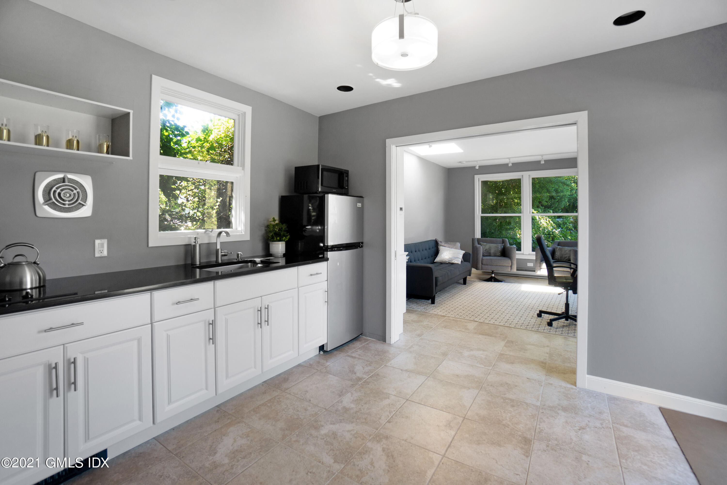 20 Ballwood Road Old Greenwich, CT 06870 - Photo 27 of 32 a large white kitchen with a large window and stainless steel appliances